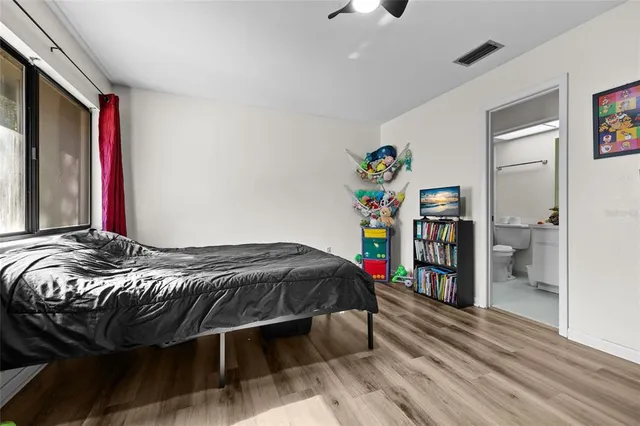 a bedroom with a bed and a bookshelf