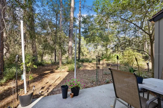 a view of backyard with outdoor seating and trees