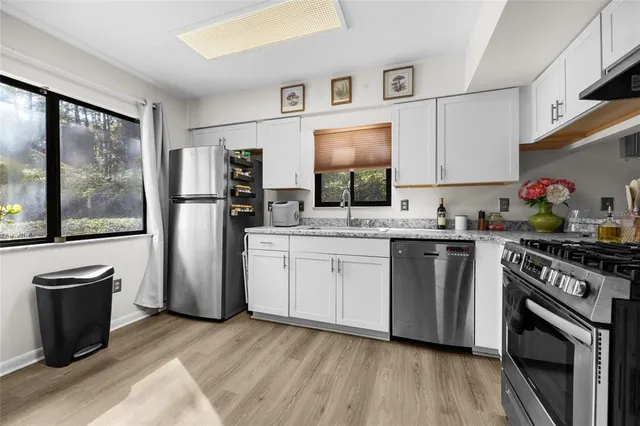 a kitchen with a refrigerator stove and sink