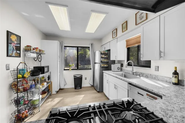 a kitchen with a sink stove and cabinets