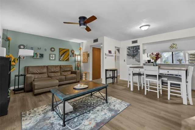 a living room with furniture and a wooden floor