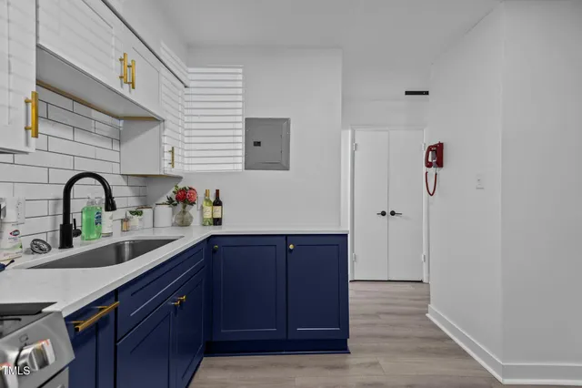 a kitchen with stainless steel appliances granite countertop a sink and wooden cabinets