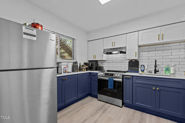 a kitchen with stainless steel appliances granite countertop a refrigerator stove a sink dishwasher and microwave