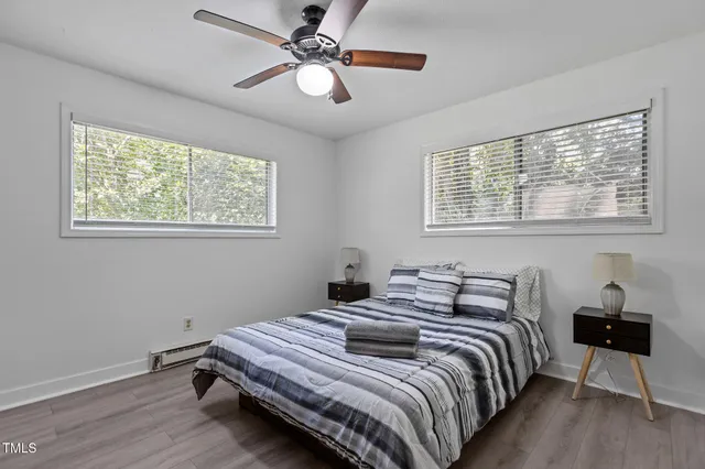 a bedroom with a bed and wooden floor