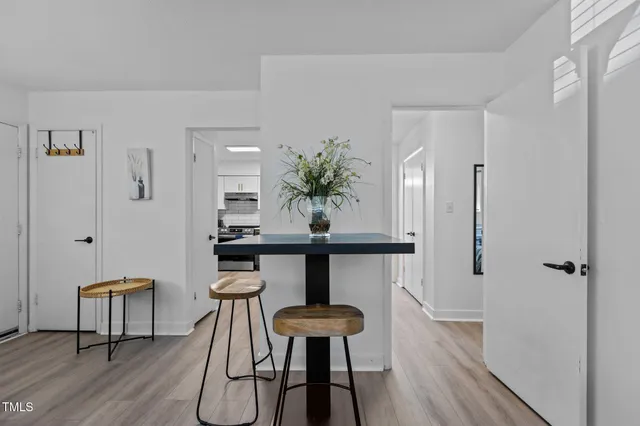 a view of a room with furniture and wooden floor