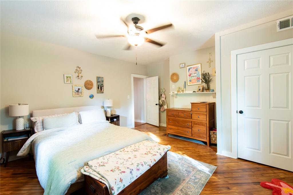 702 Radford Street Monroe, GA 30655 - Photo 13 of 49 a bedroom with a bed and wooden floor