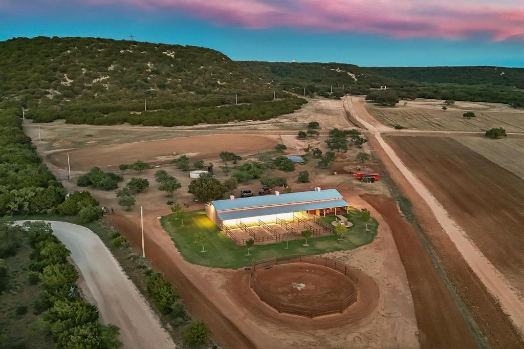 635 County Road 184 Winters, TX 79567 - Photo 15 of 40 Aerial view of property and surrounding area featuring a heavily wooded area