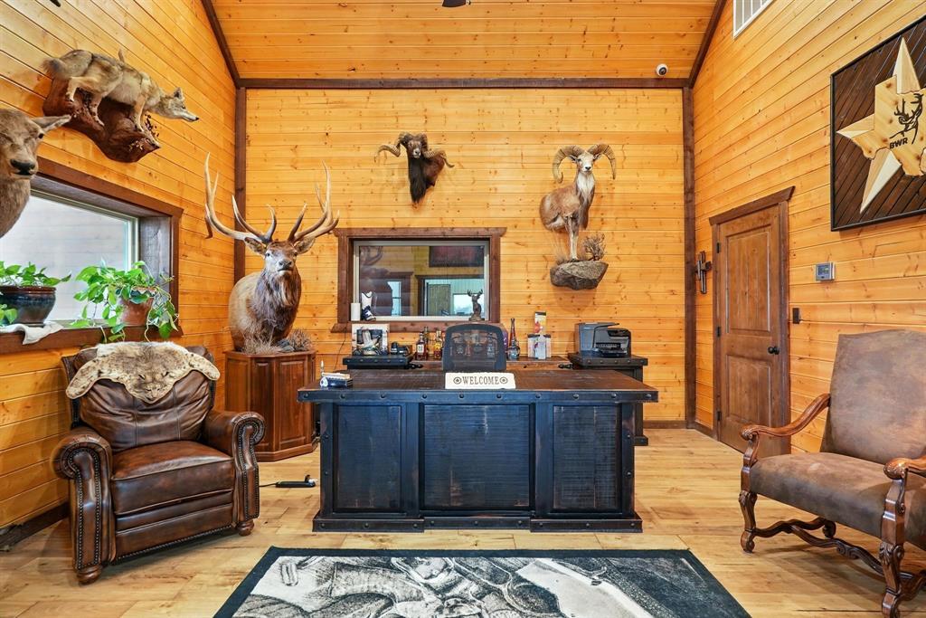 635 County Road 184 Winters, TX 79567 - Photo 28 of 40 Home office with wooden walls, light wood-style floors, vaulted ceiling, and wooden ceiling
