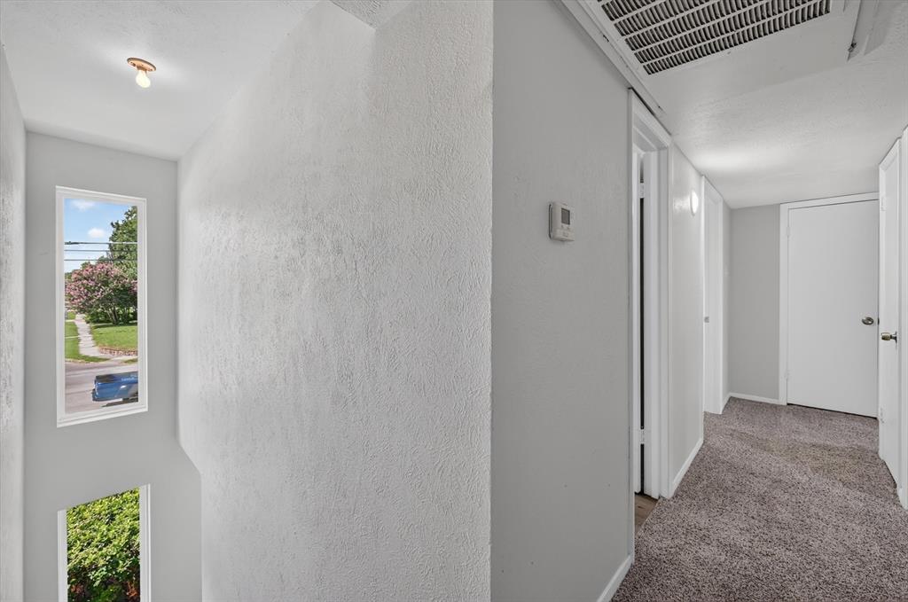 1801 East Grauwyler Road, Unit 101 Irving, TX 75061 - Photo 13 of 39 a view of hallway with window and wooden floor