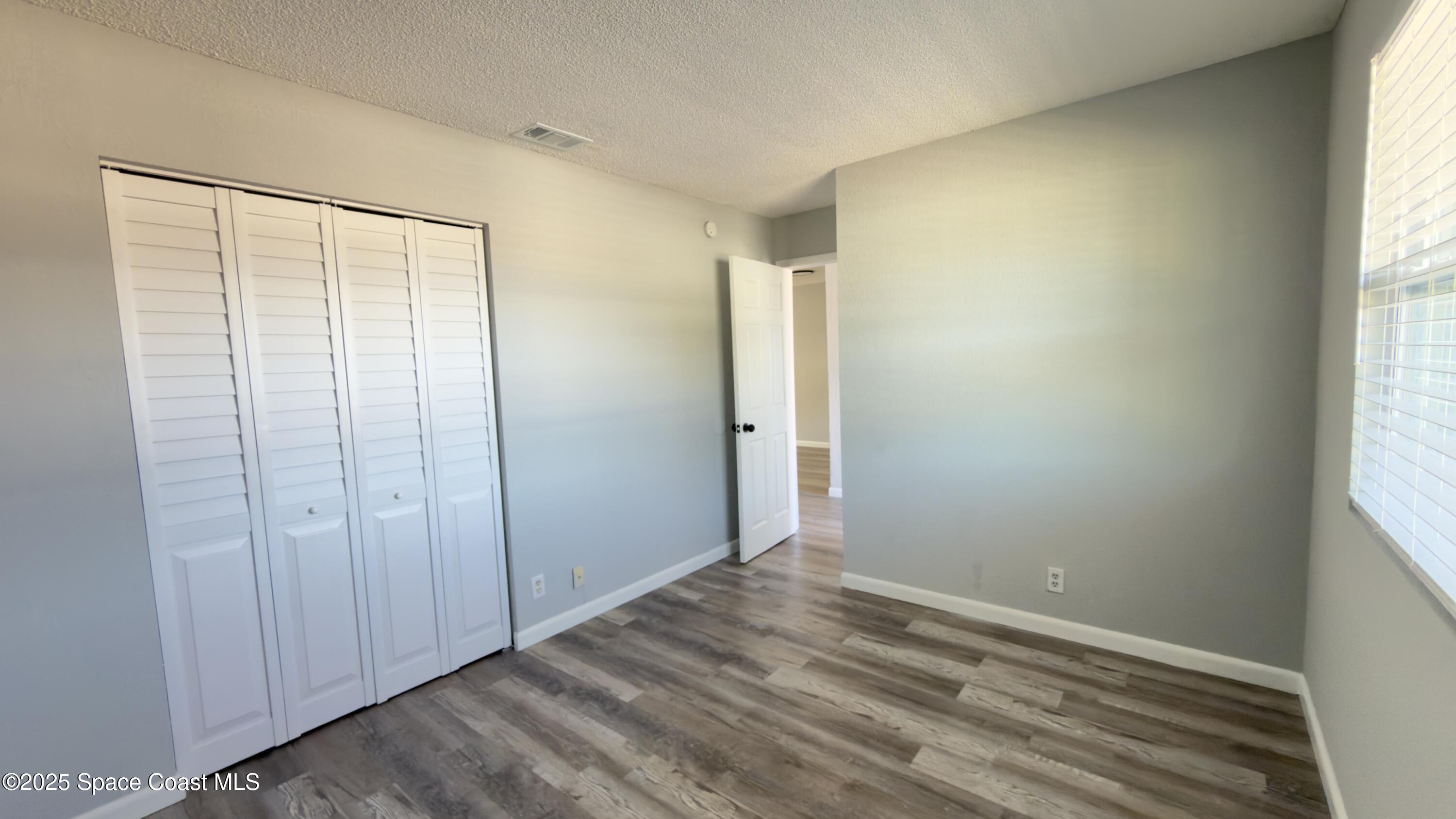 4160 Barna Avenue, Unit C Titusville, FL 32780 - Photo 11 of 14 an empty room with windows
