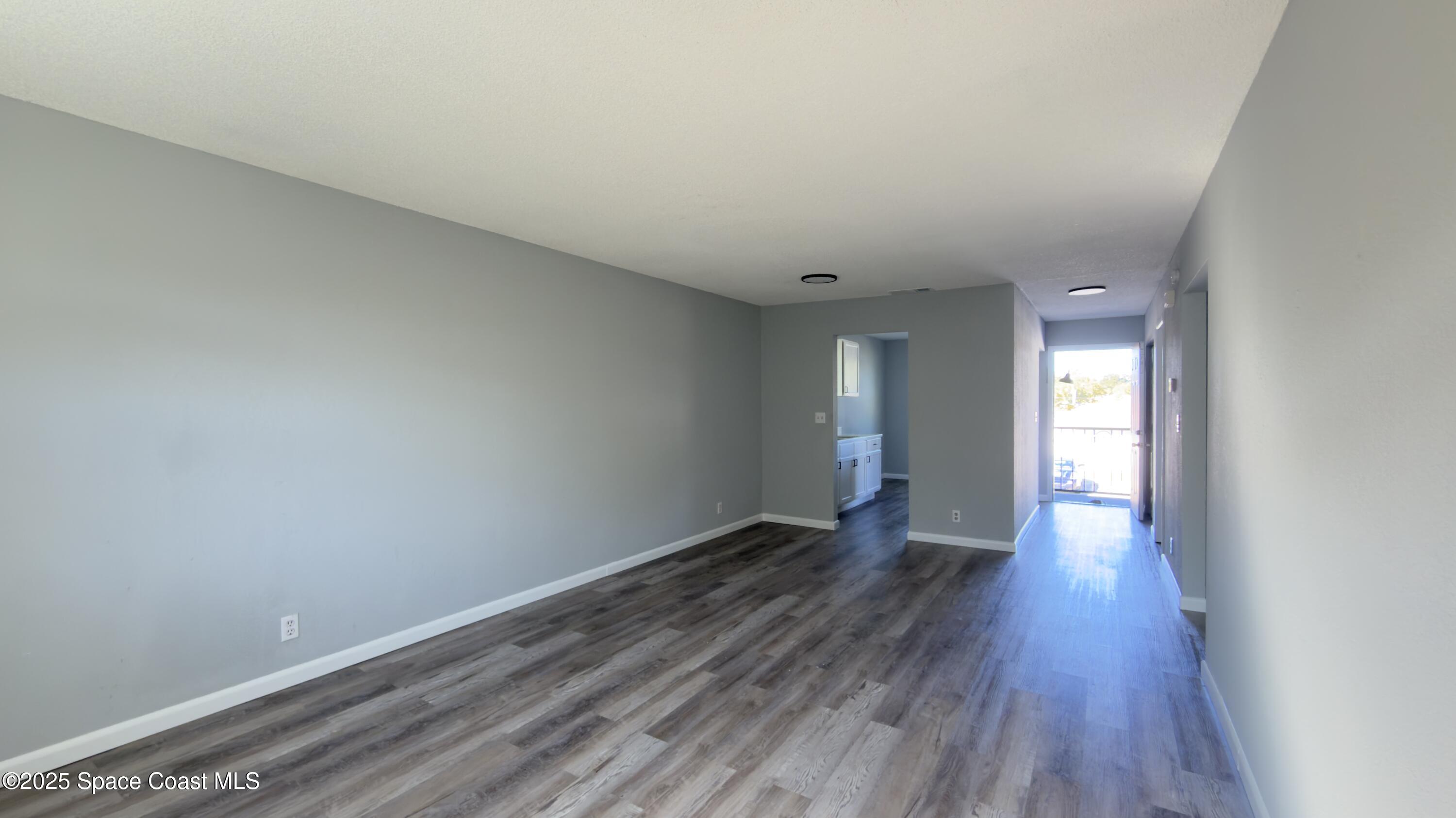 4160 Barna Avenue, Unit C Titusville, FL 32780 - Photo 5 of 14 a view of an empty room and wooden floor
