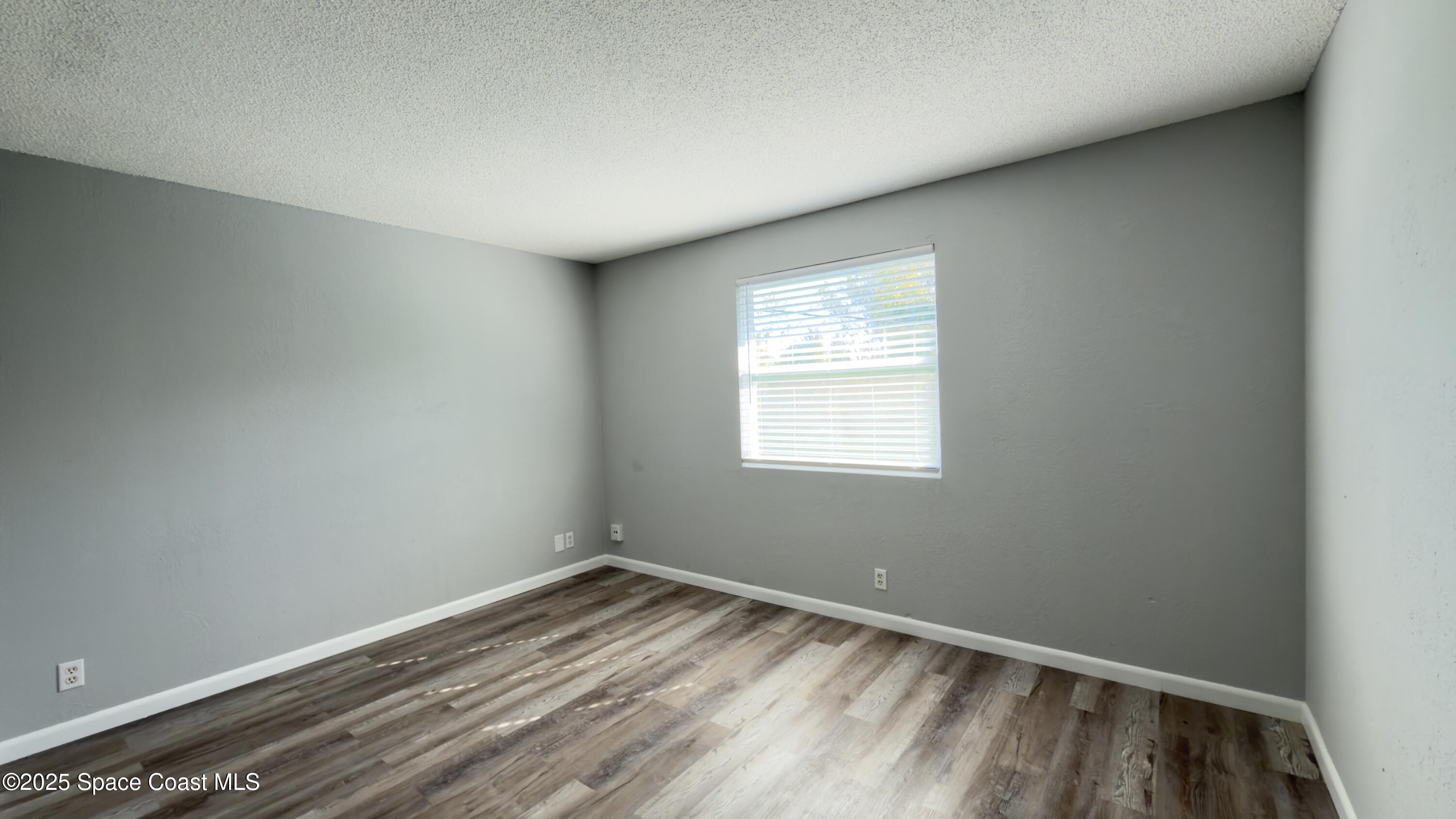 4160 Barna Avenue, Unit C Titusville, FL 32780 - Photo 9 of 14 an empty room with a window