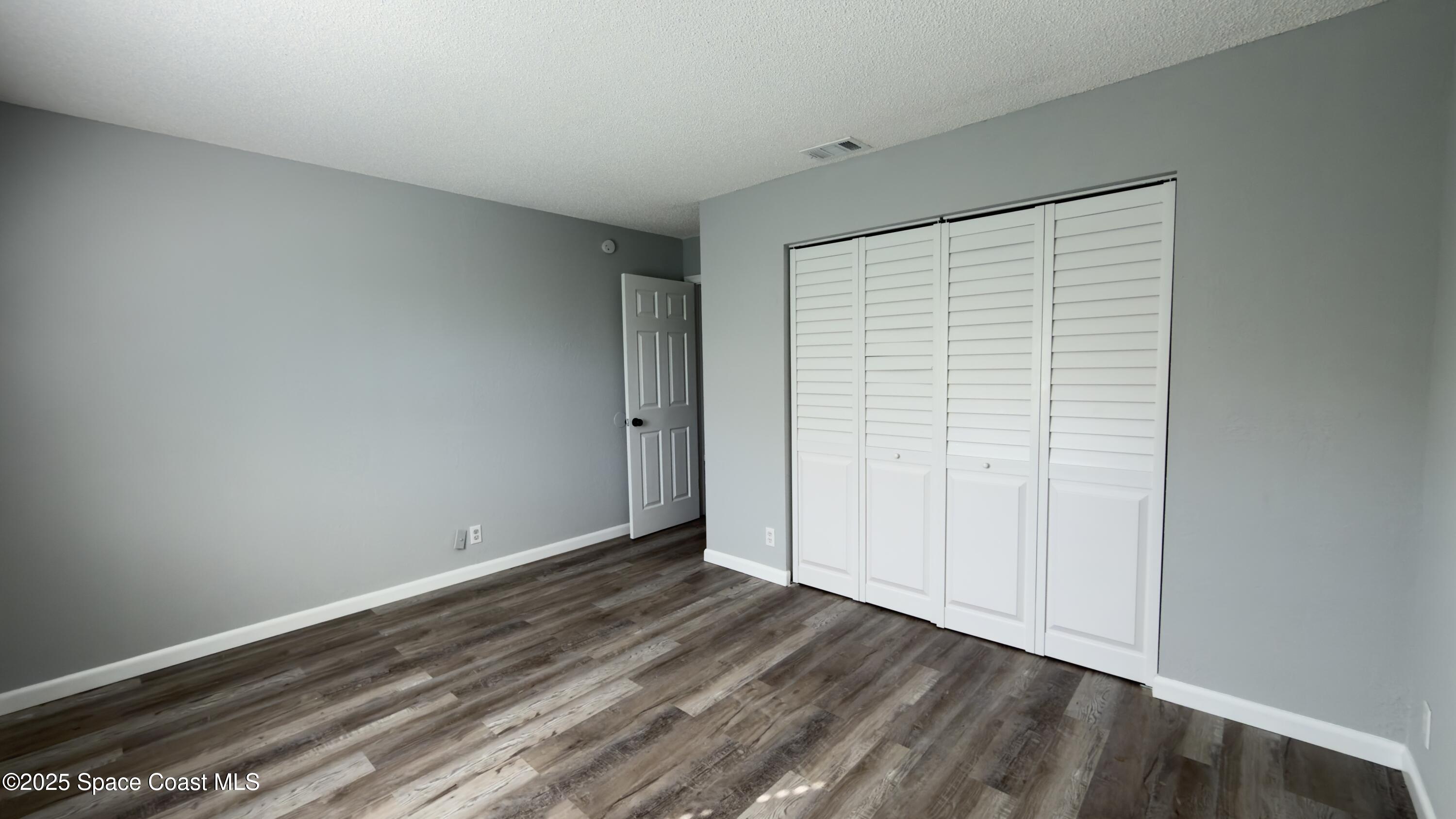 4160 Barna Avenue, Unit C Titusville, FL 32780 - Photo 10 of 14 a view of an empty room with wooden floor