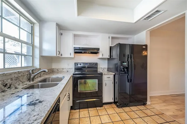 a kitchen with a refrigerator sink and stove