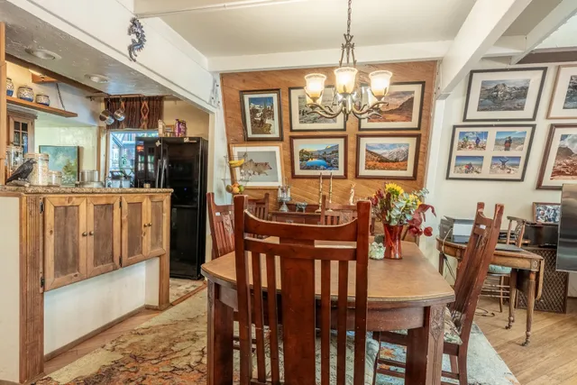 a view of a dining room with furniture and chandelier
