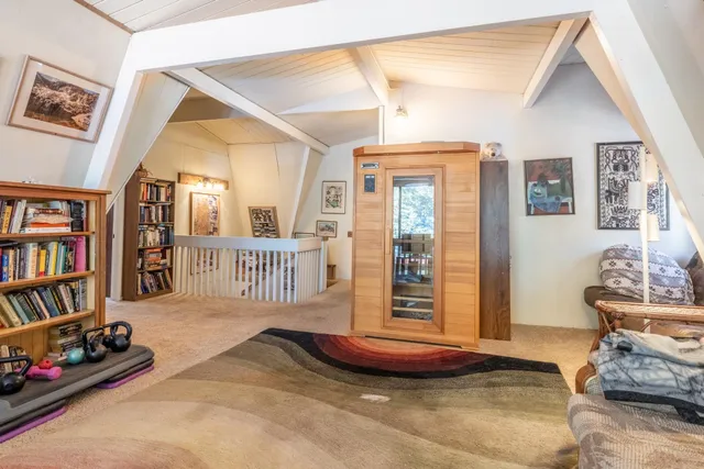 a bedroom with a bed next to a window