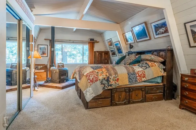 a bathroom with double vanity sinks a toilet a mirror and shower