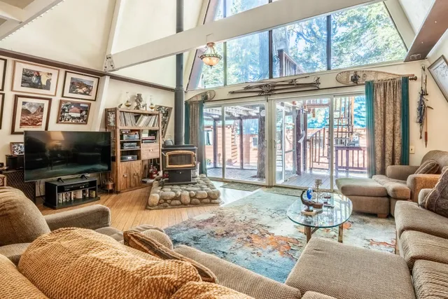 a living room with furniture wooden floor and a large window