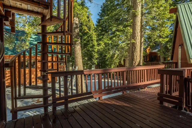 a view of balcony with wooden floor and fence