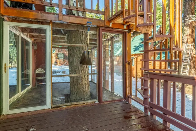 a view of a balcony with wooden floor and fence