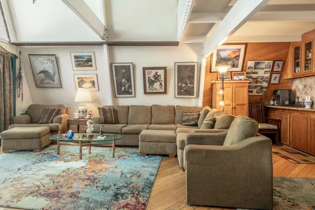 a living room with furniture and a chandelier