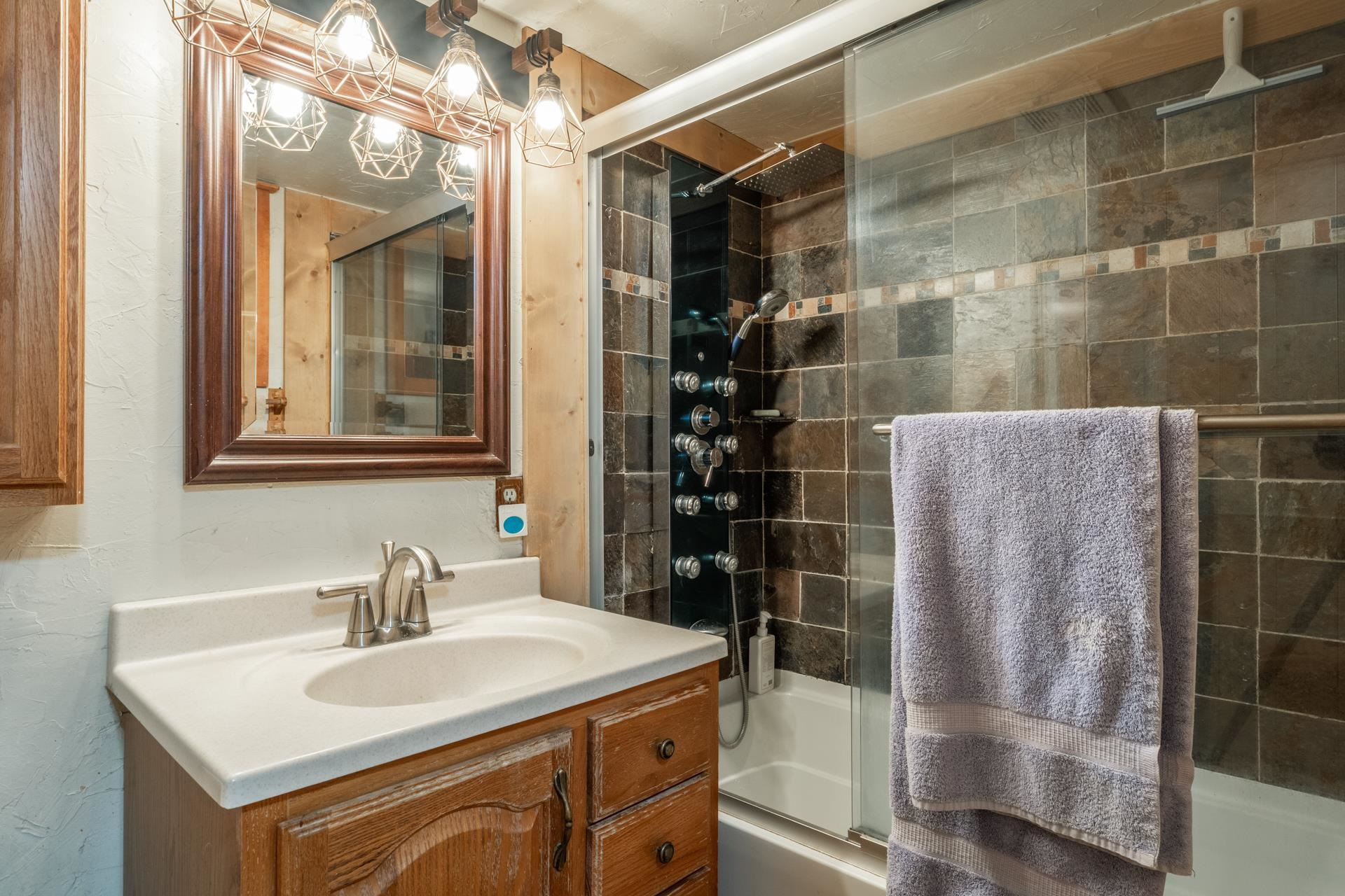 64 Mill Street Mammoth Lakes, CA 93546 - Photo 9 of 27 Full bathroom featuring enclosed tub / shower combo and vanity