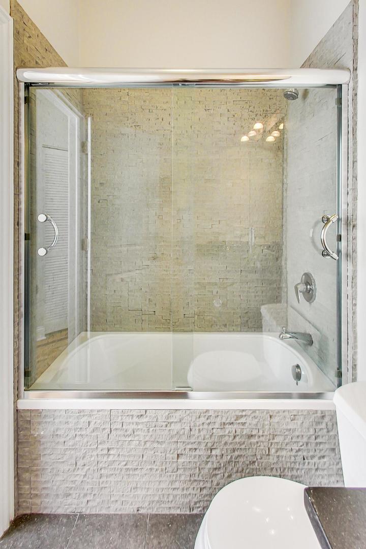 2448 West Augusta Boulevard, Unit 2 Chicago, IL 60622 - Photo 17 of 23 a bathroom with a bathtub and shower