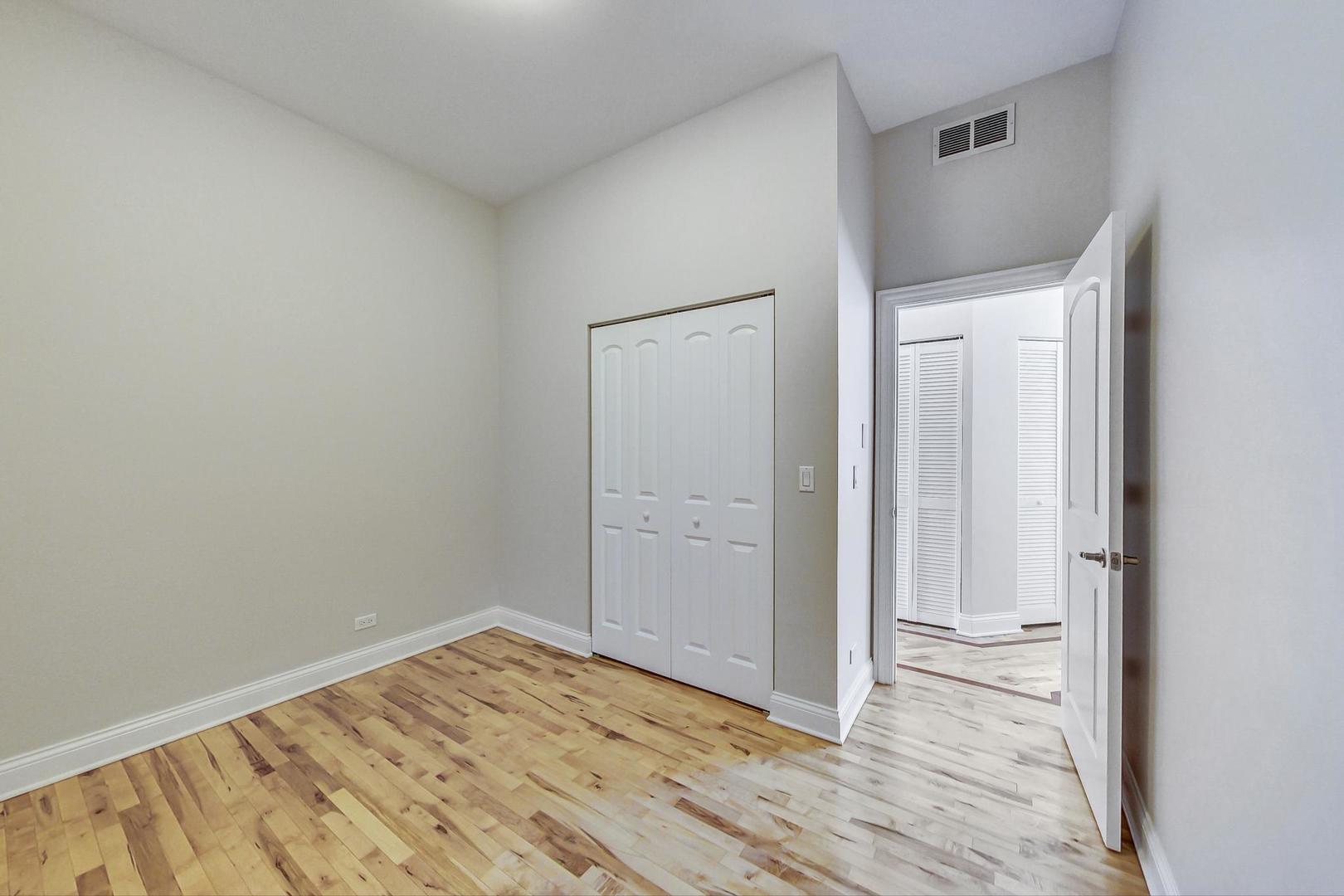 2448 West Augusta Boulevard, Unit 2 Chicago, IL 60622 - Photo 18 of 23 a view of a room with wooden floor and bathroom