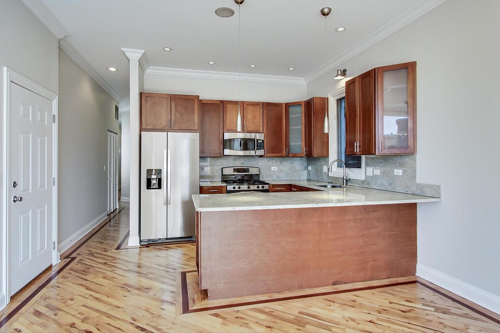 2448 West Augusta Boulevard, Unit 2 Chicago, IL 60622 - Photo 3 of 23 a kitchen with stainless steel appliances granite countertop a refrigerator a stove and a sink