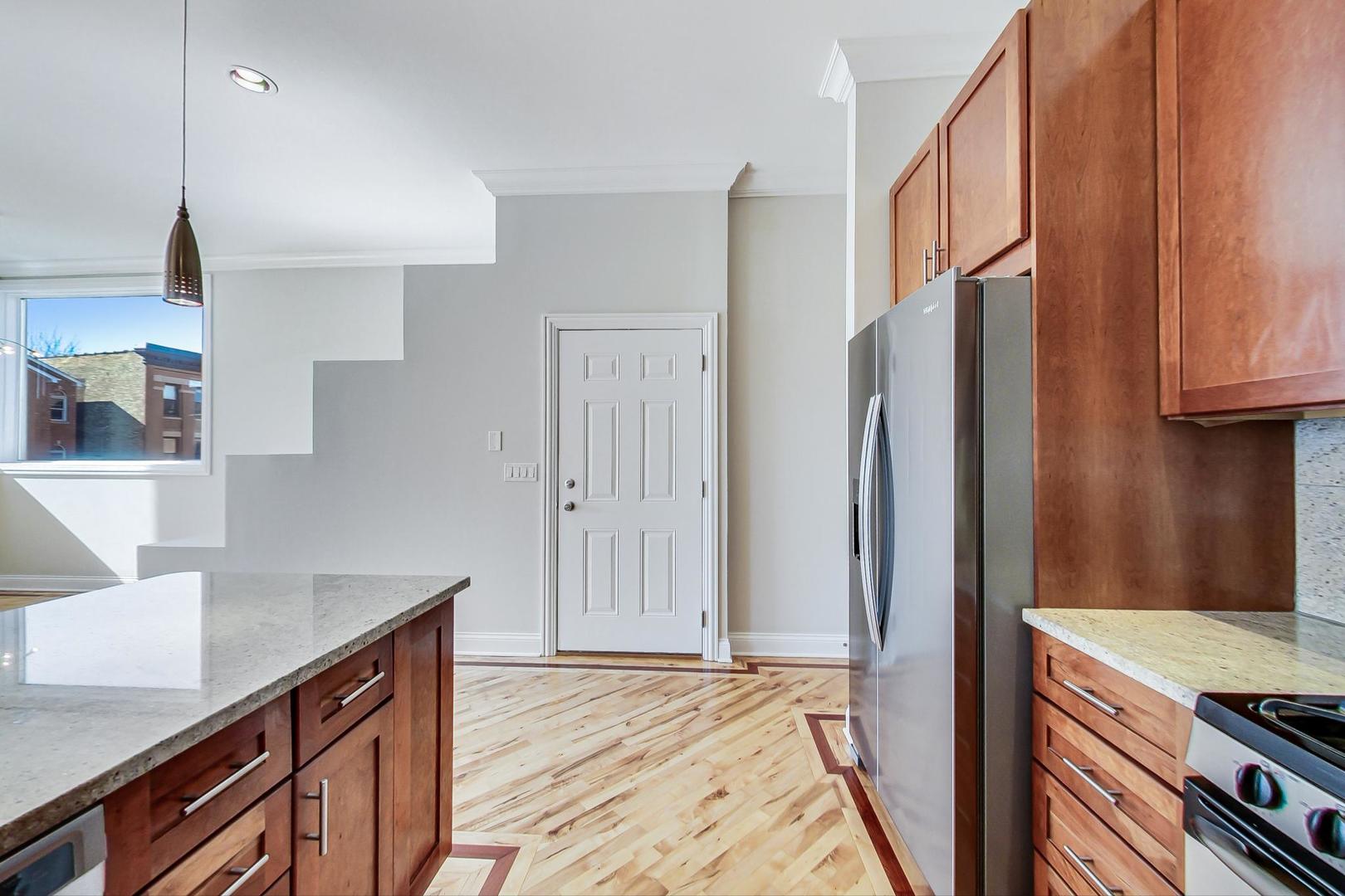 2448 West Augusta Boulevard, Unit 2 Chicago, IL 60622 - Photo 5 of 23 a kitchen with stainless steel appliances granite countertop a refrigerator and a stove