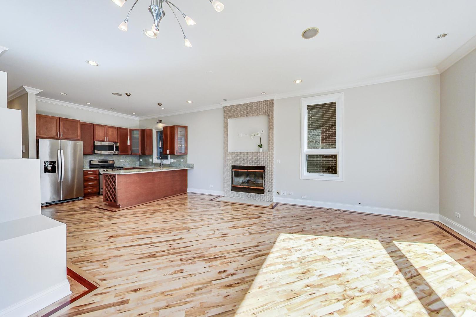 2448 West Augusta Boulevard, Unit 2 Chicago, IL 60622 - Photo 7 of 23 a view of kitchen with cabinets and wooden floor