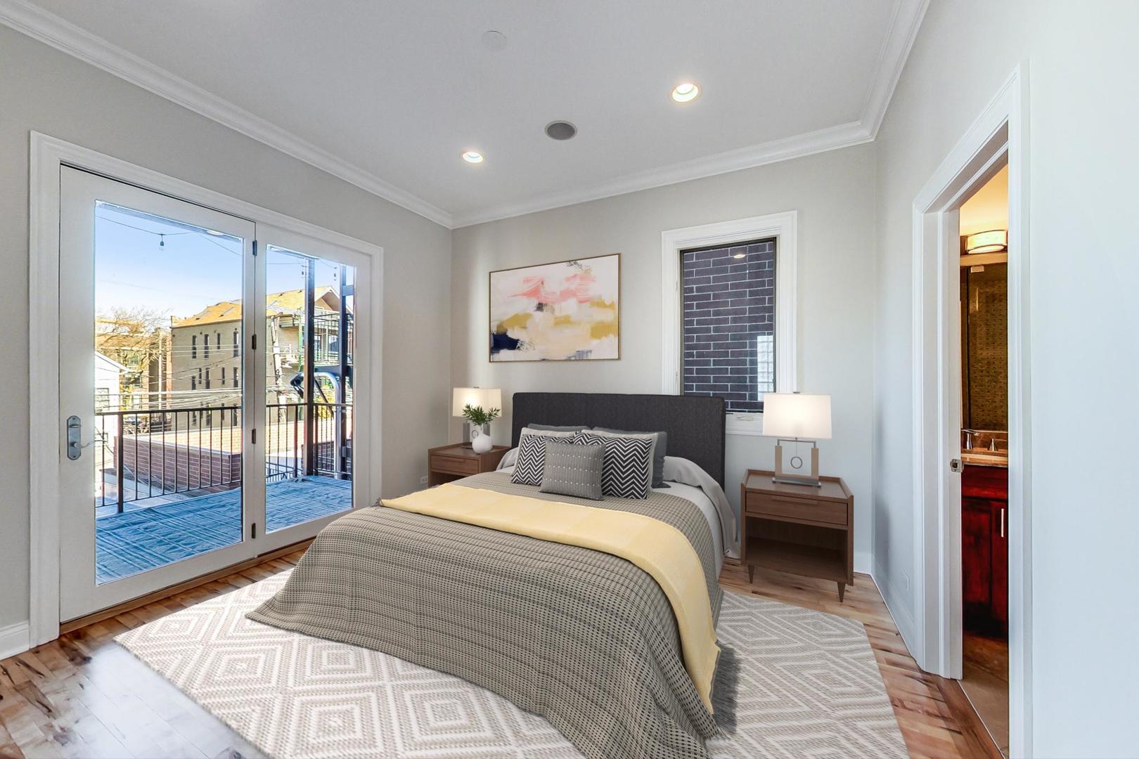 2448 West Augusta Boulevard, Unit 2 Chicago, IL 60622 - Photo 10 of 23 a bedroom with a large bed and a large window