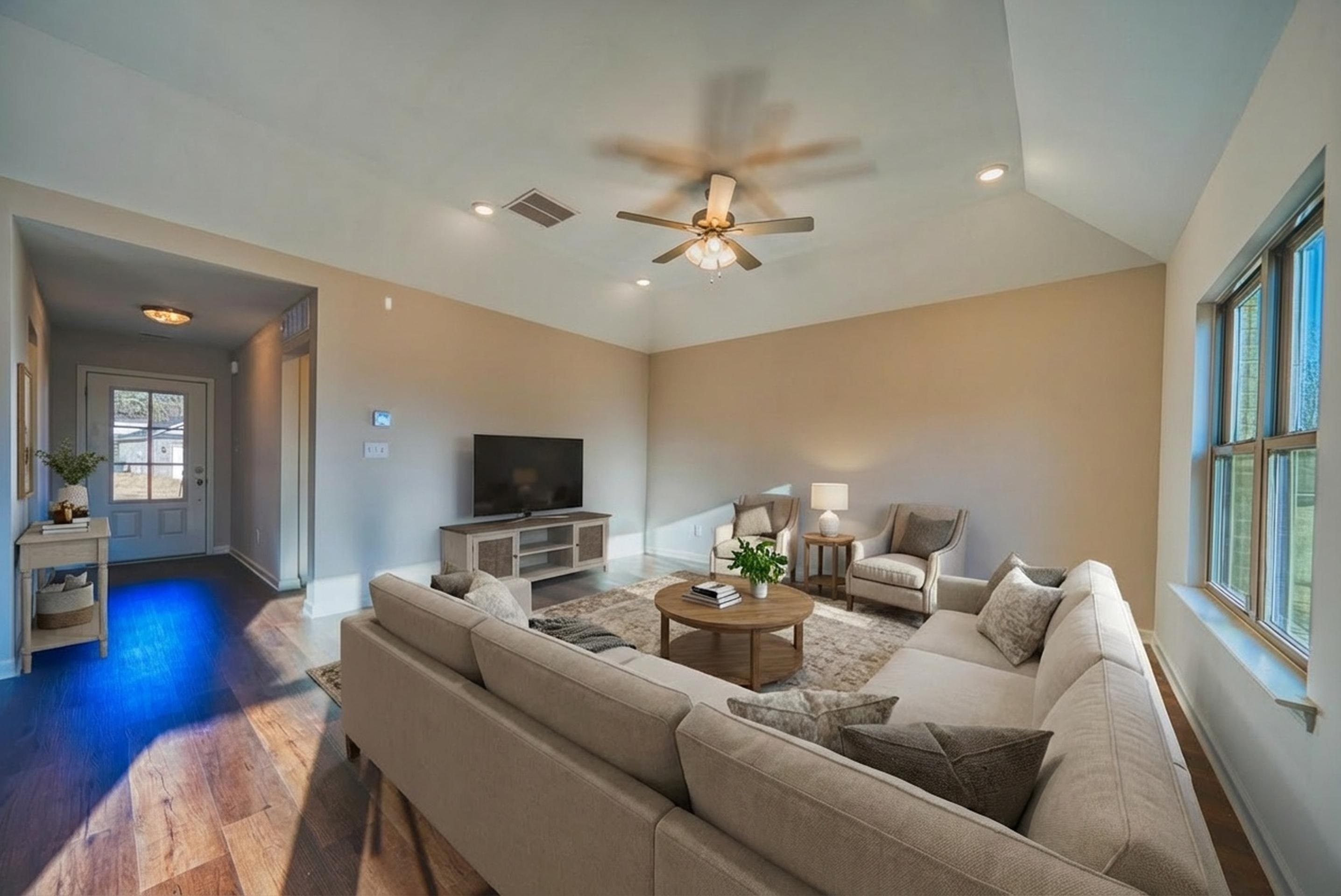 Living area featuring recessed lighting, ceiling fan, wood finished floors, and vaulted ceiling