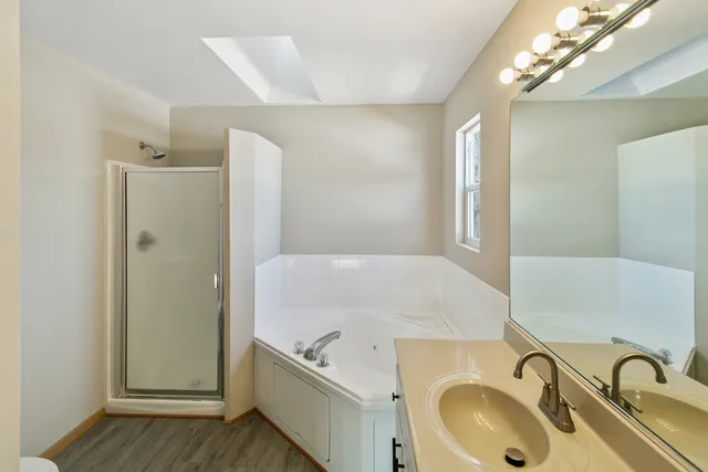 a bath room with a sink tub and shower
