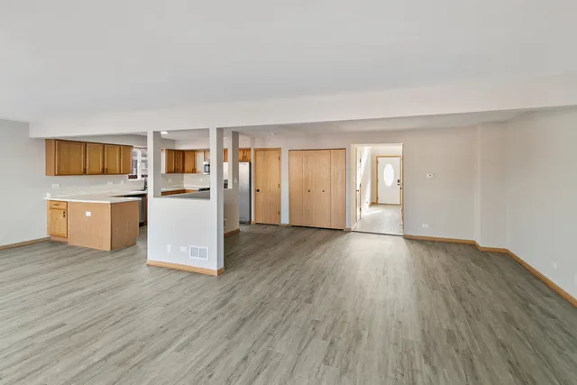 a view of kitchen with wooden floor and electronic appliances