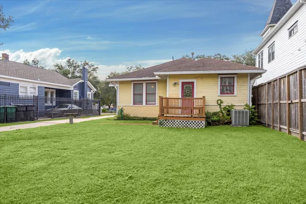 a view of a house with a yard and sitting area