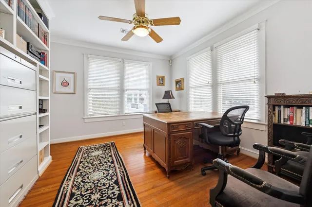 a view of a workspace with furniture and a window