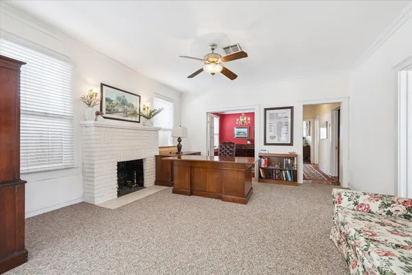 a living room with furniture and a fireplace