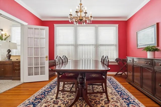 a dining room with furniture a rug and a chandelier