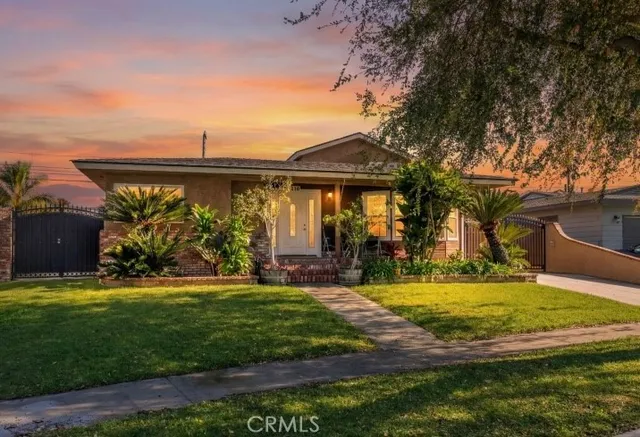 a view of a house with swimming pool and a yard