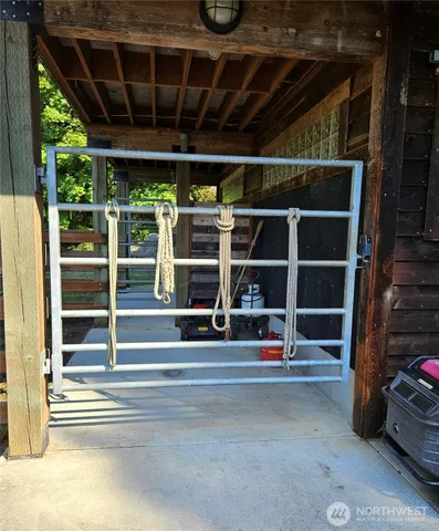 a view of an empty room with wooden floor and windows