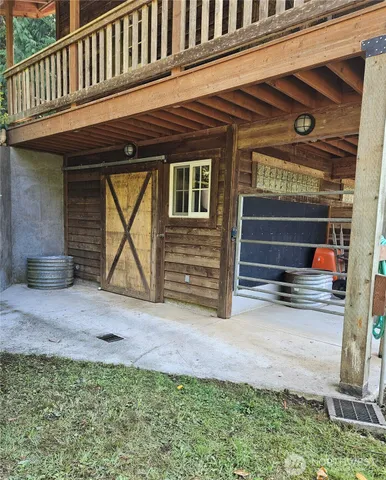 a view of a house with a small yard and wooden fence