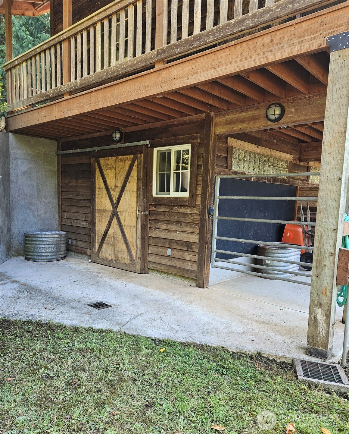 106 Crocker Lake Road Quilcene, WA 98376 - Photo 19 of 38 a view of a house with a small yard and wooden fence