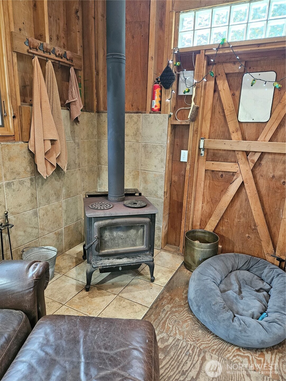106 Crocker Lake Road Quilcene, WA 98376 - Photo 29 of 38 a living room with furniture and a fireplace
