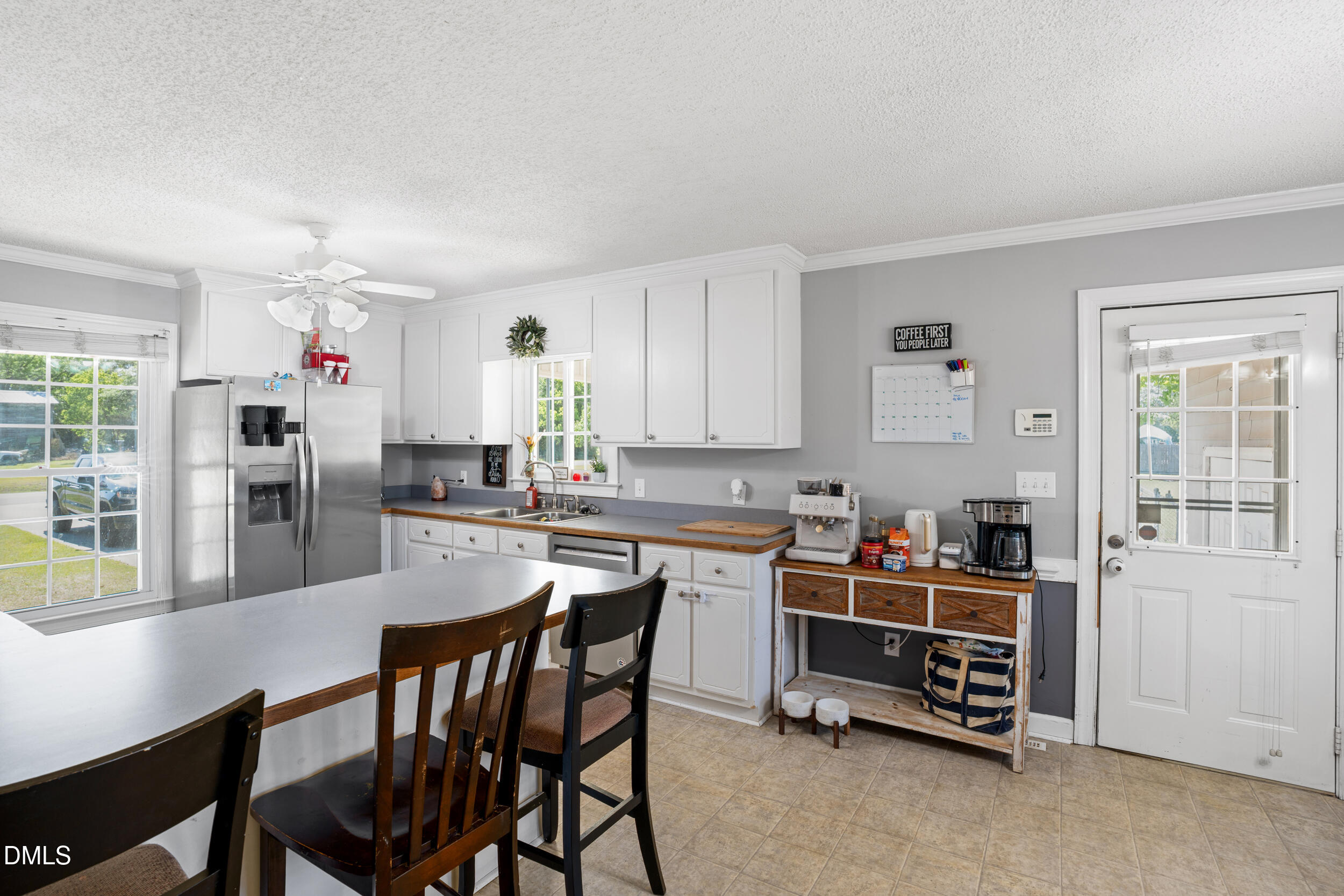 311 Bridgers Road Kenly, NC 27542 - Photo 6 of 46 a kitchen with stainless steel appliances a stove a table and chairs