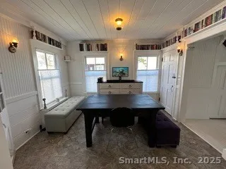 a view of a workspace with furniture and window