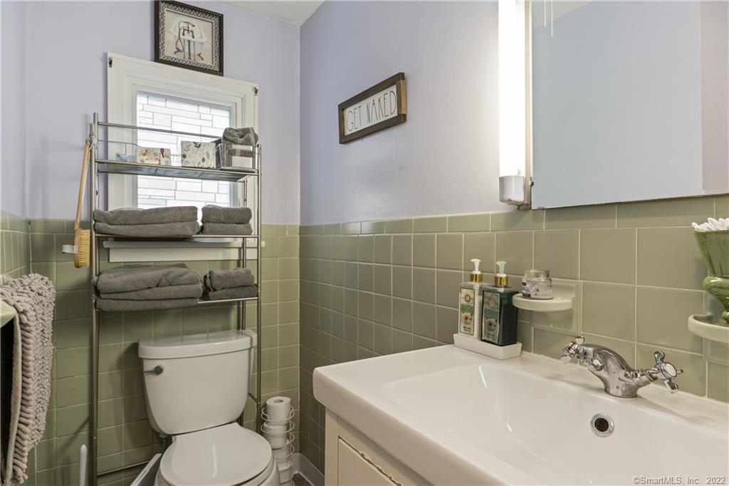 624 Vineyard Point Road Guilford, CT 06437 - Photo 12 of 38 a bathroom with a toilet sink and mirror