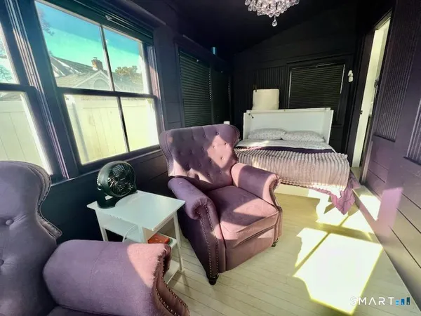 a bedroom with a bed a couch and dresser