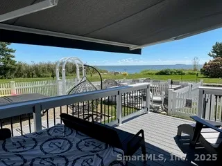 a view of a balcony with wooden floor and outdoor space