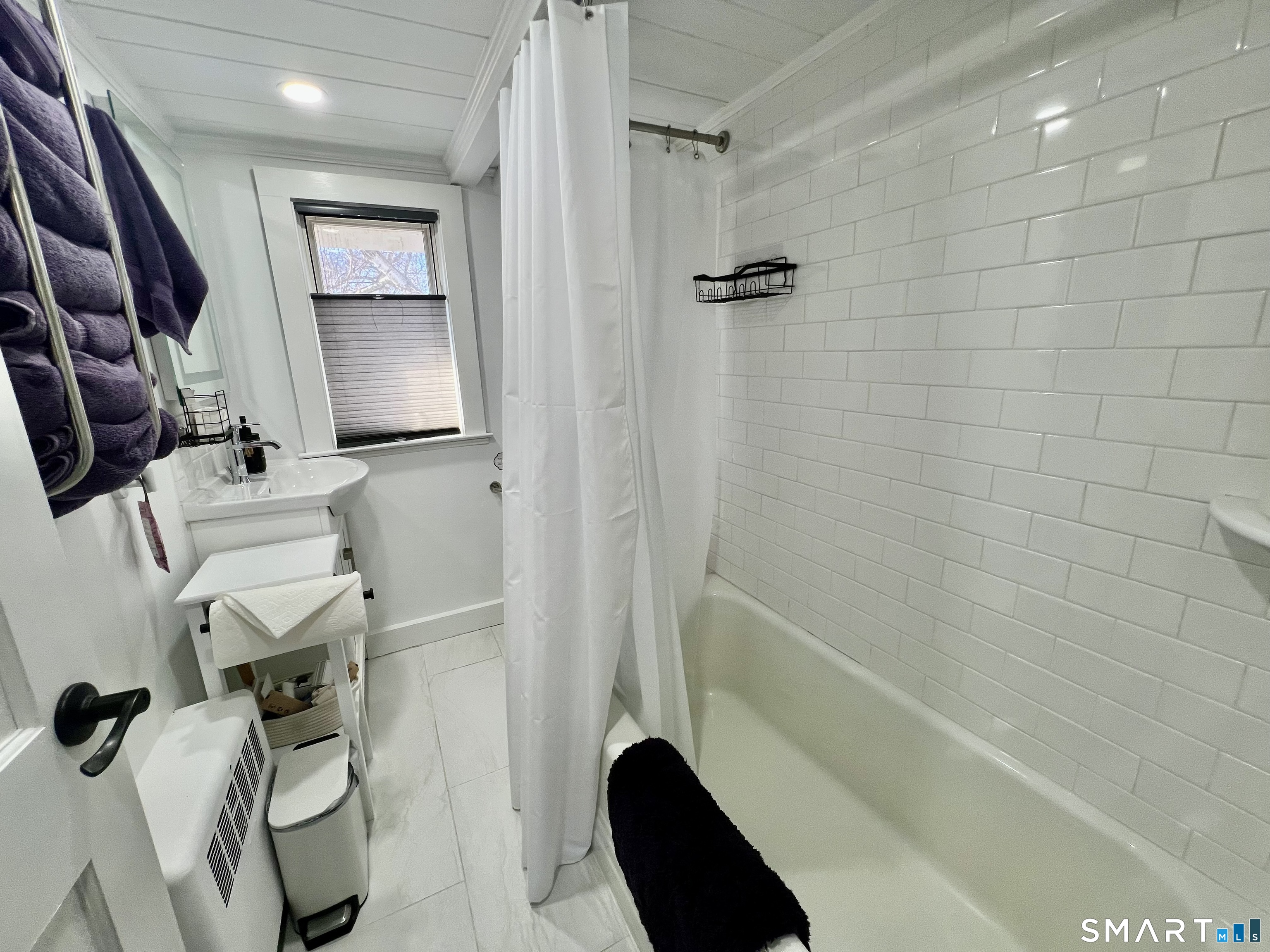 624 Vineyard Point Road Guilford, CT 06437 - Photo 22 of 40 a bathroom with a tub a sink and a shower